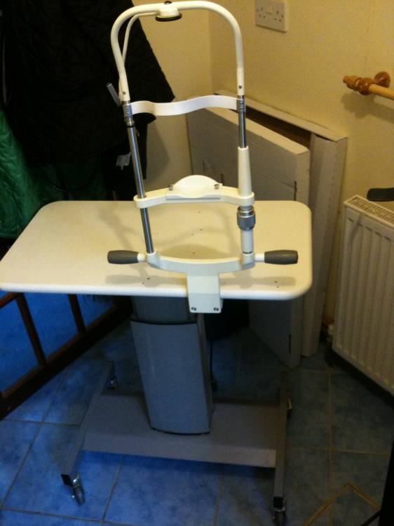 Motorized slit lamp table with chin rest mount att